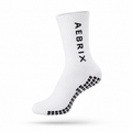 A single white crew sock with black grip dots on the sole and the brand name 'AEBRIX' printed vertically in black on the side, shown against a plain white background.