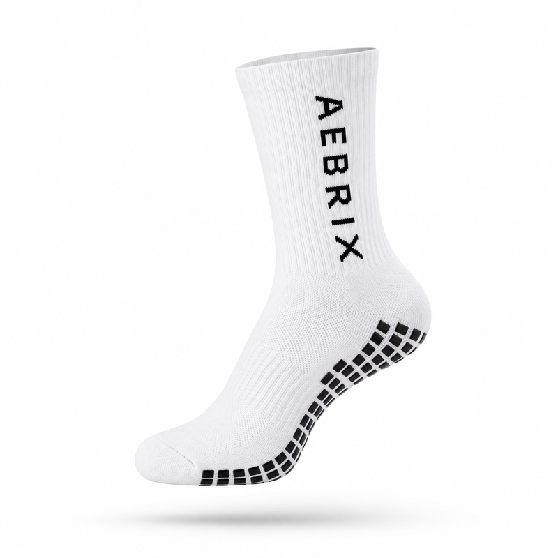 A single white crew sock with black grip dots on the sole and the brand name 'AEBRIX' printed vertically in black on the side, shown against a plain white background.